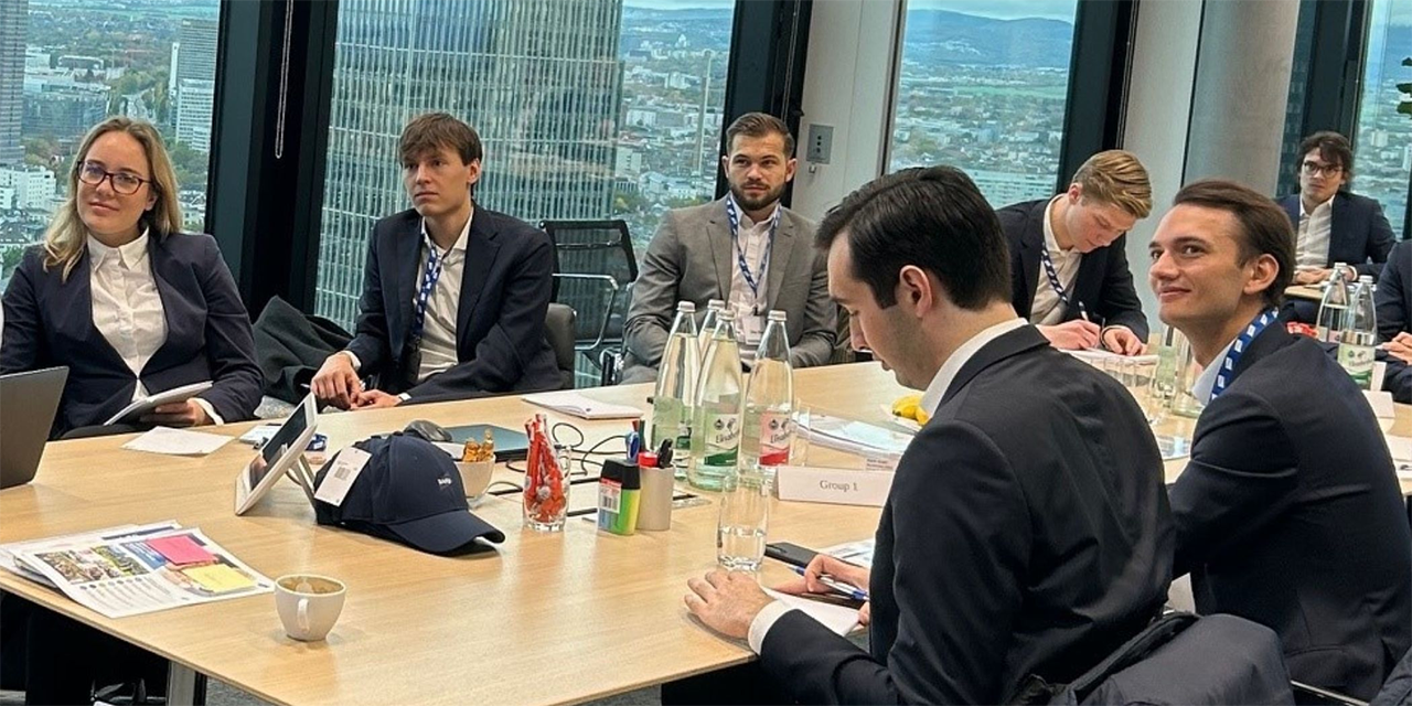 Young professionals sitting at a conference room table engaged in conversation