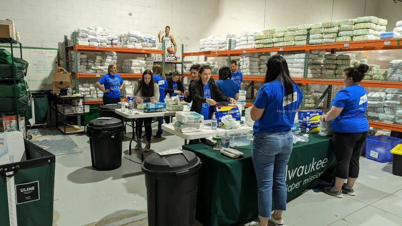 Baird associates volunteering packaging diapers at the Milwaukee Diaper MIssion.