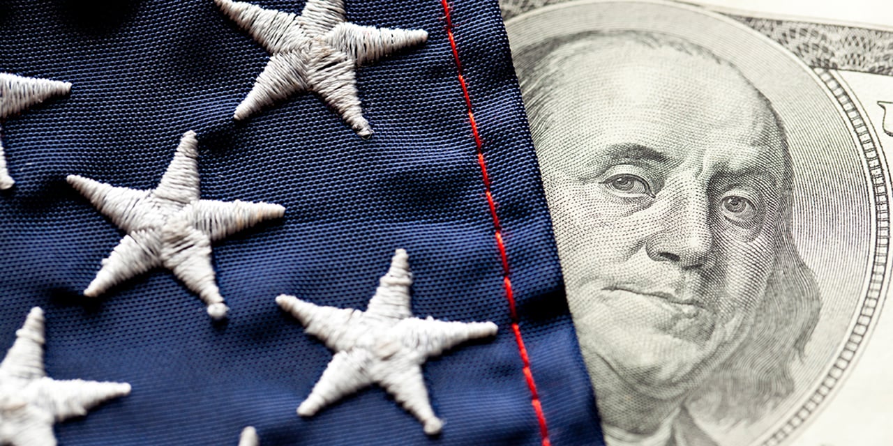 Image of part of a U.S. flag covering a 100 dollar bill.
