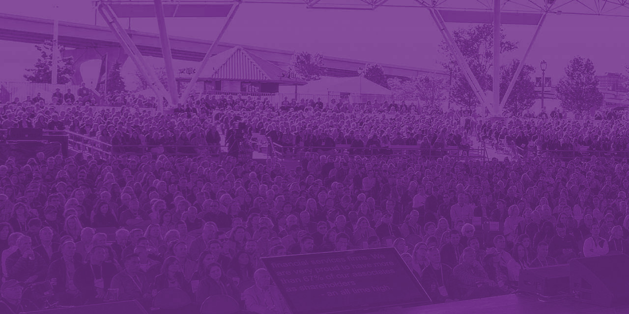 Purple overlay on an image of hundreds of Baird associates at the 2019 annual meeting