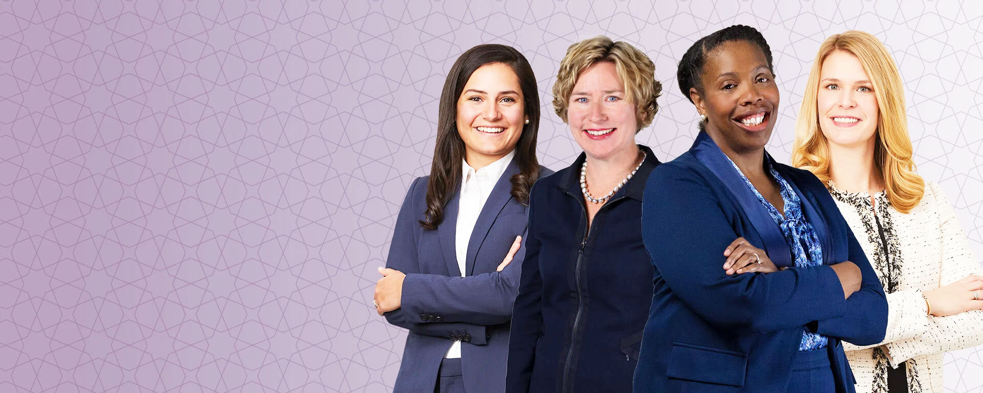 Four women in professional attire standing as a group with a purple background.