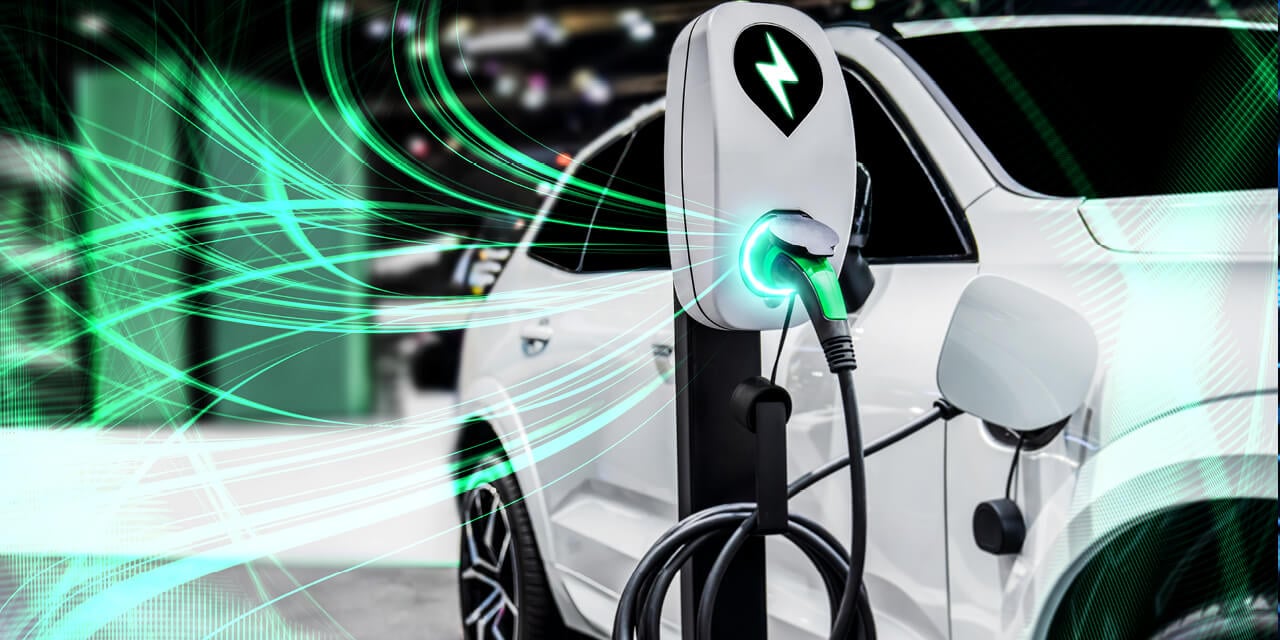 Abstract image of an electric vehicle at a charging station surrounded by translucent green lines to represent electricity.