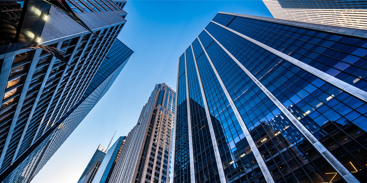 Upward view of skyscrapers against a blue sky