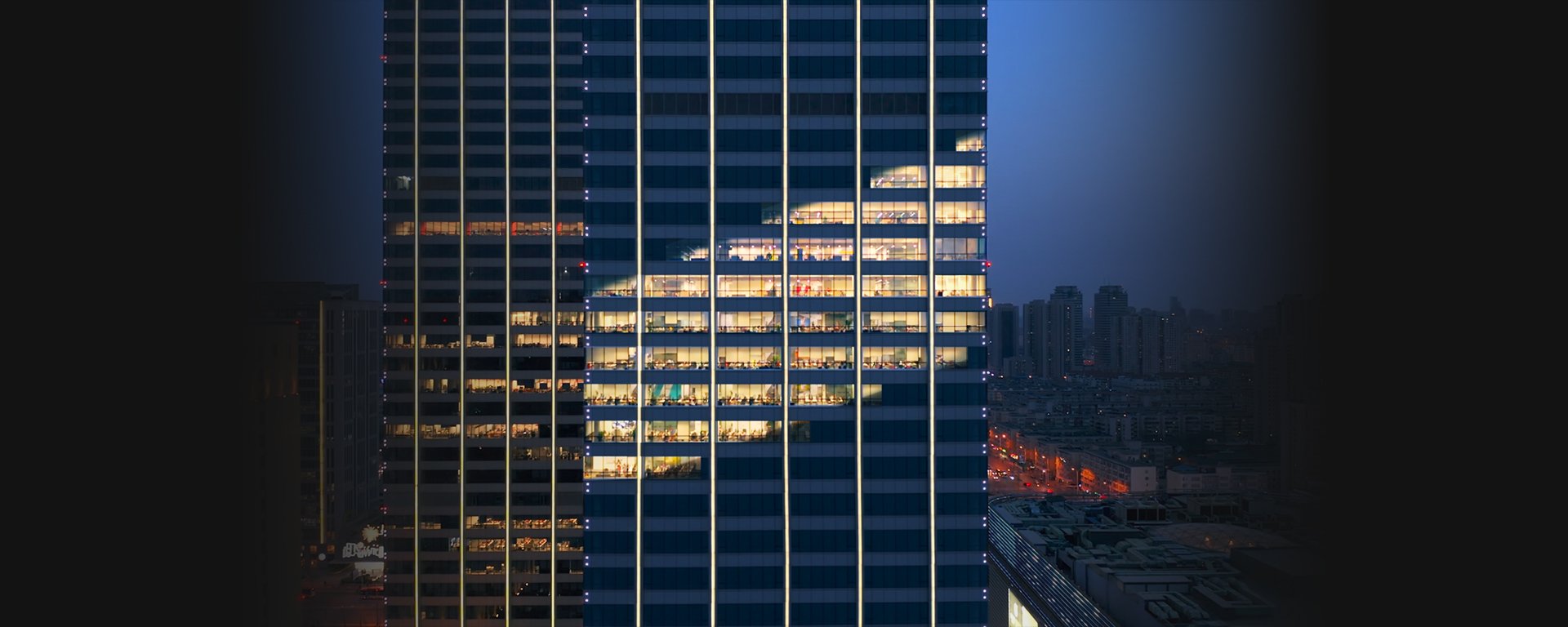 Building with the shape of the Baird logo in lights.