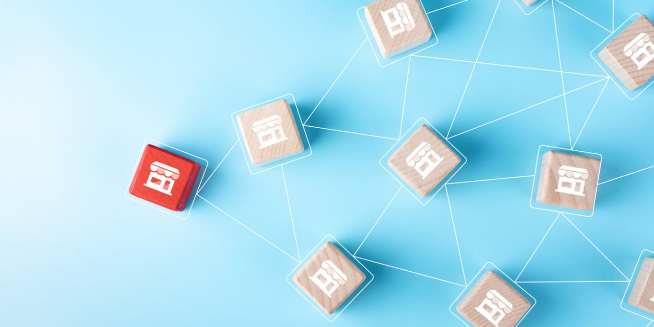 Connected storefront icons illustrating a multi-location business network