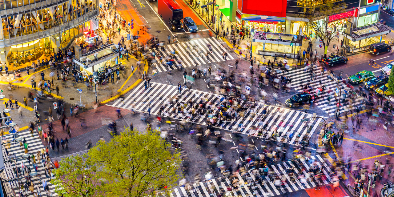 Overhead image of cross walks filled with people is a large city