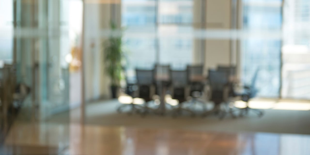 Blurred image of an empty conference room.