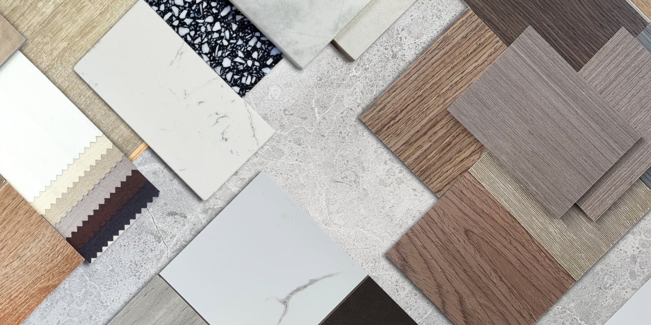 Samples of wood, stone and fabric laying on a table.