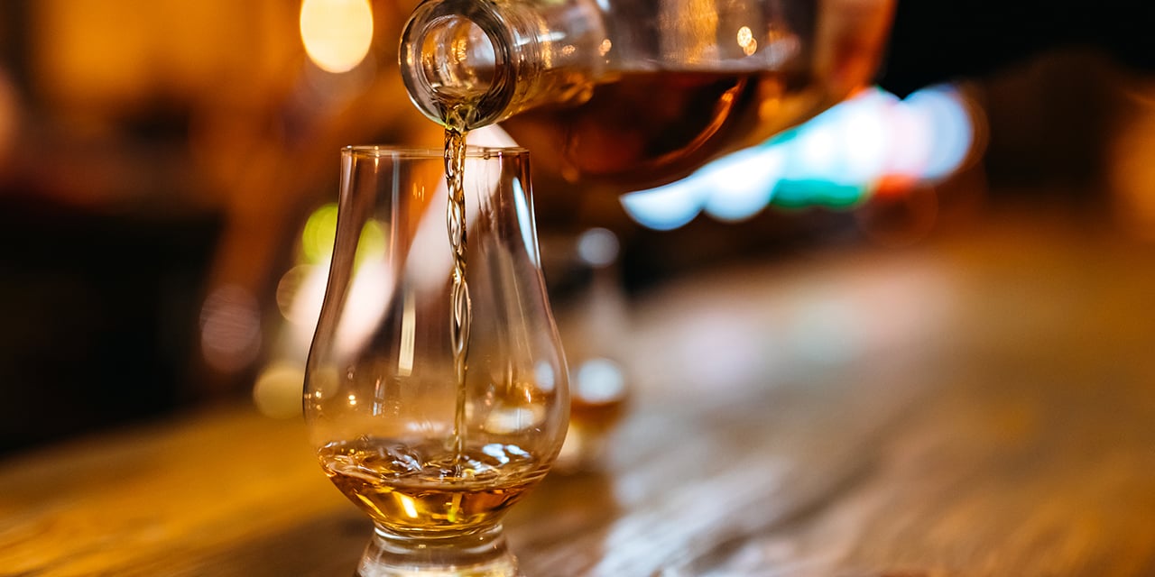 Bourbon being poured into a glass.