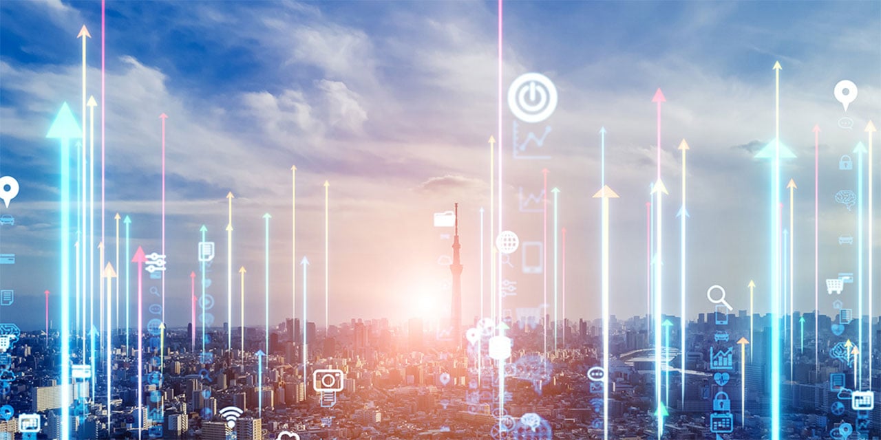 Abstract image of city scape with technology icons floating above the city.