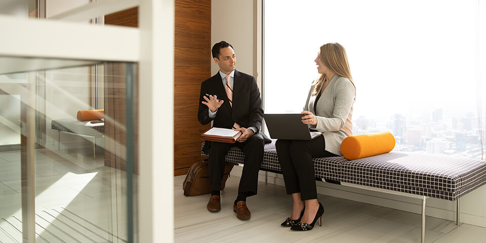 Two Fixed Income Capital Markets associates collaborate in an open workspace