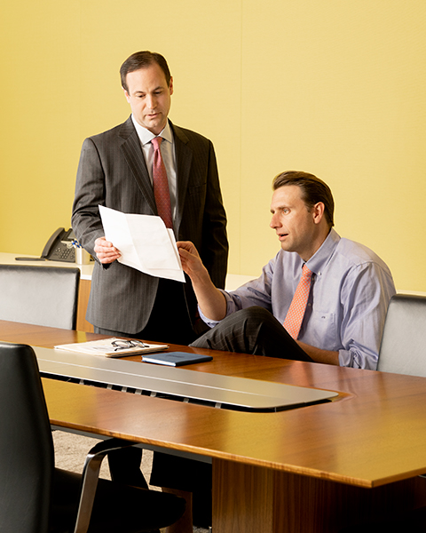Fixed Income Capital Markets associates review a document in a conference room