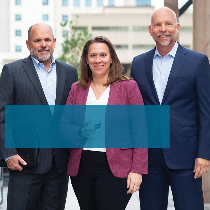 Three associates from the Private Wealth Management branch standing outside