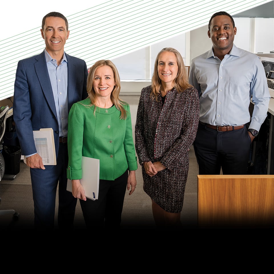 Four members of Baird Asset Management in an office setting