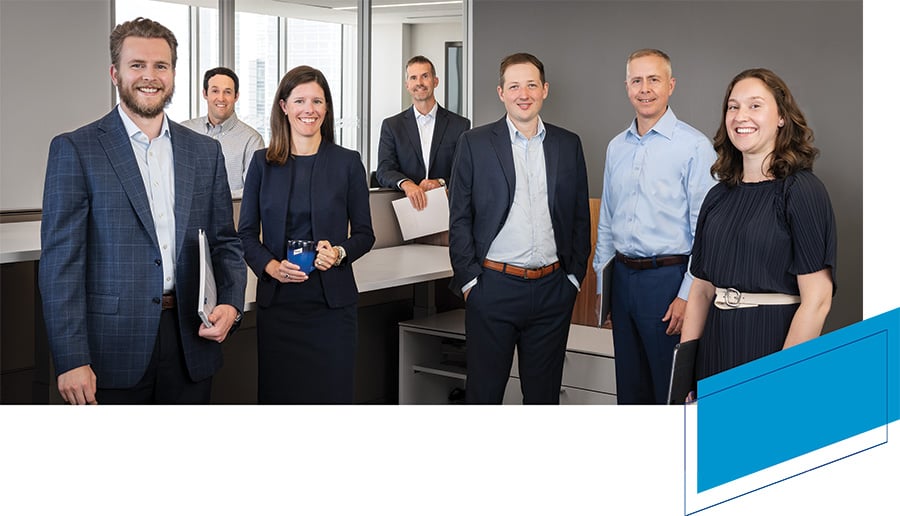 A group of associates from Baird Asset Management in an office setting