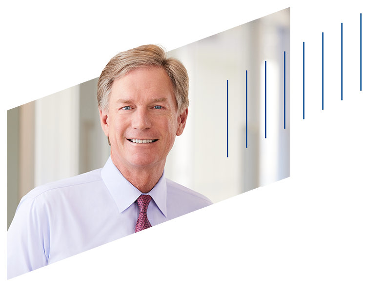 Steve Booth framed by paralellograms in the shape of the Baird logo