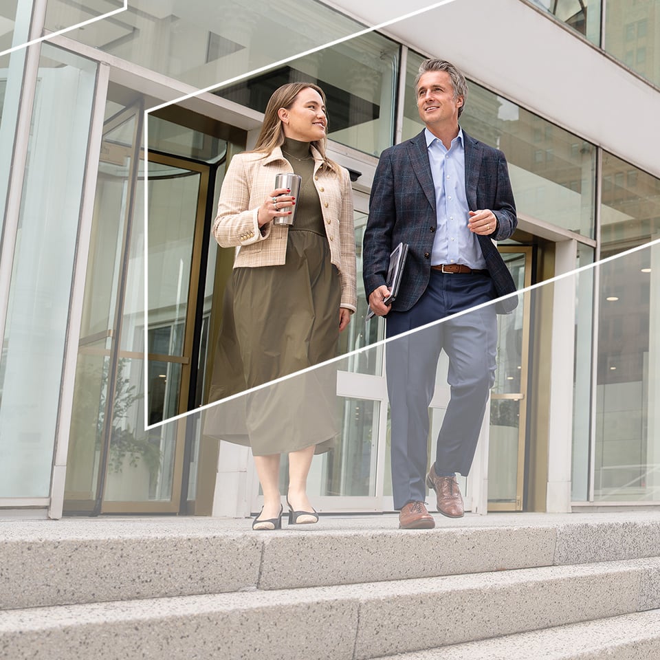 Two associates from Baird Equity Capital Markets walking outside of Baird's Milwaukee office building