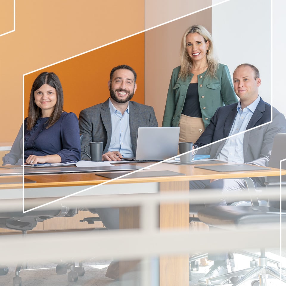 Four associates from Baird Principal Investments in an office conference room