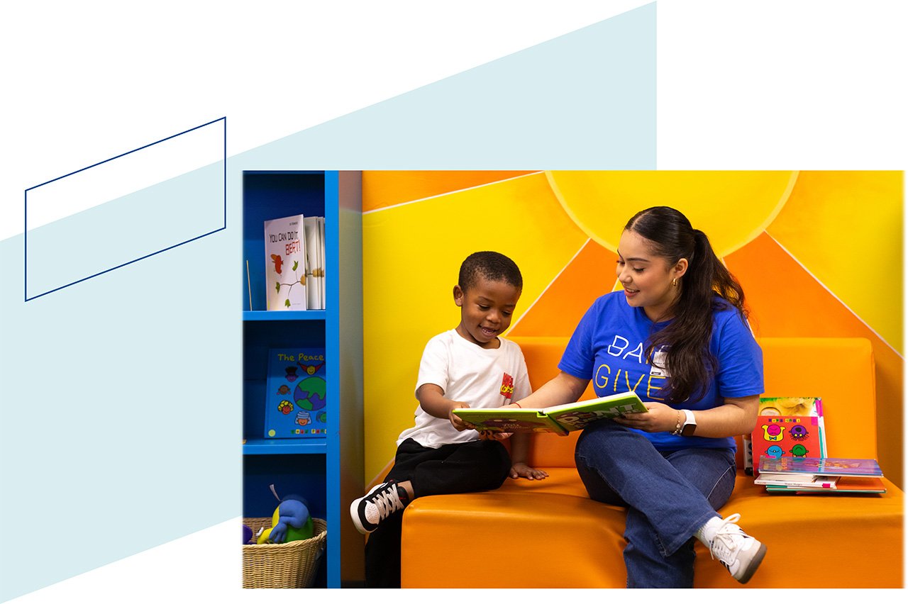A Baird associate reading with a child during Baird Gives Back week