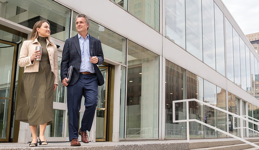 Two associates from Baird Equity Capital Markets walking outside of Baird's Milwaukee office building