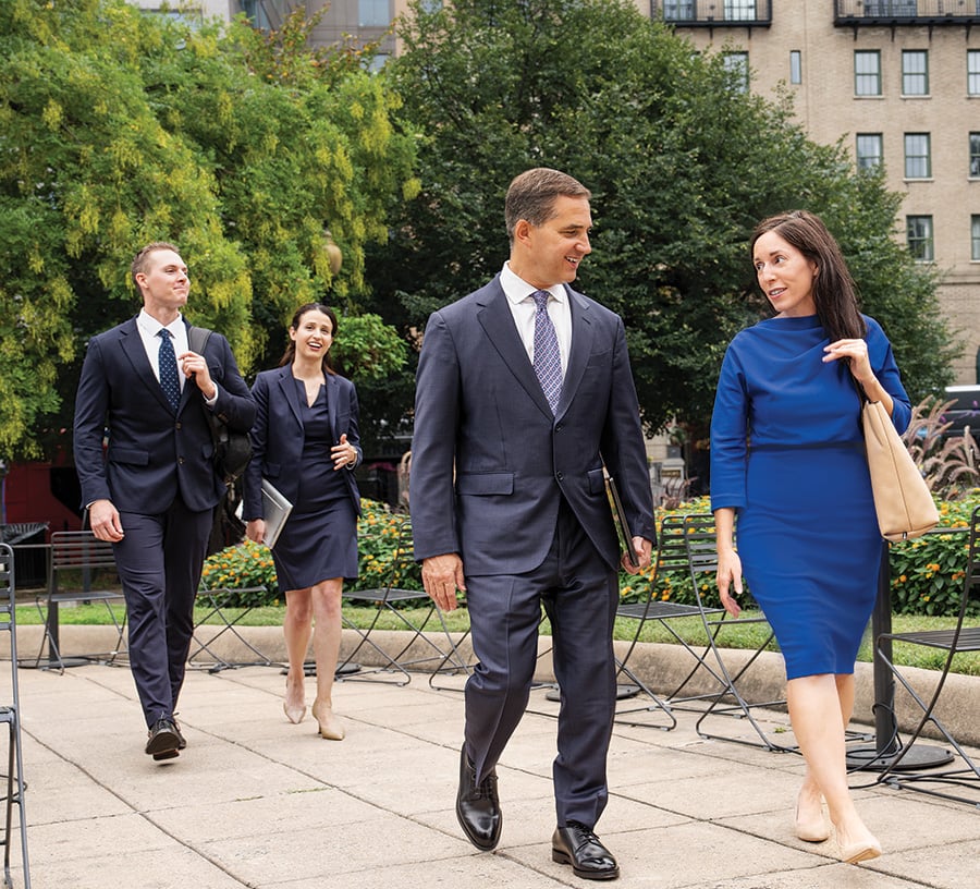 Four associates from Baird Equity Capital Markets walking outside office buildings