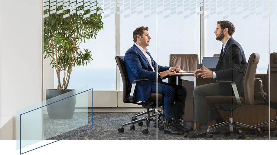Two associates from Baird Fixed Income Capital Markets having a discussion in a conference room
