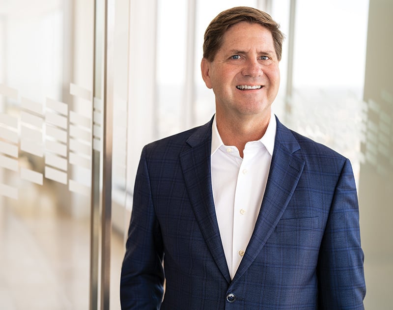 An associate from Baird Fixed Income Capital Markets standing in a Baird office