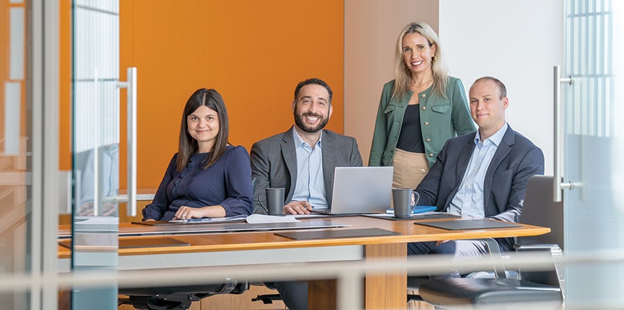 Four associates from Baird Principal Investments in an office conference room
