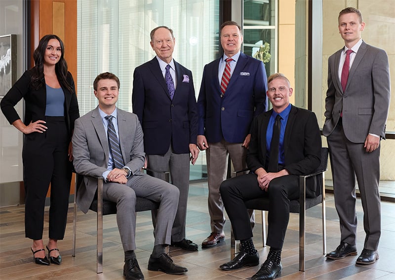 Six Baird Private Wealth Management associates dressed in office attire in an office setting
