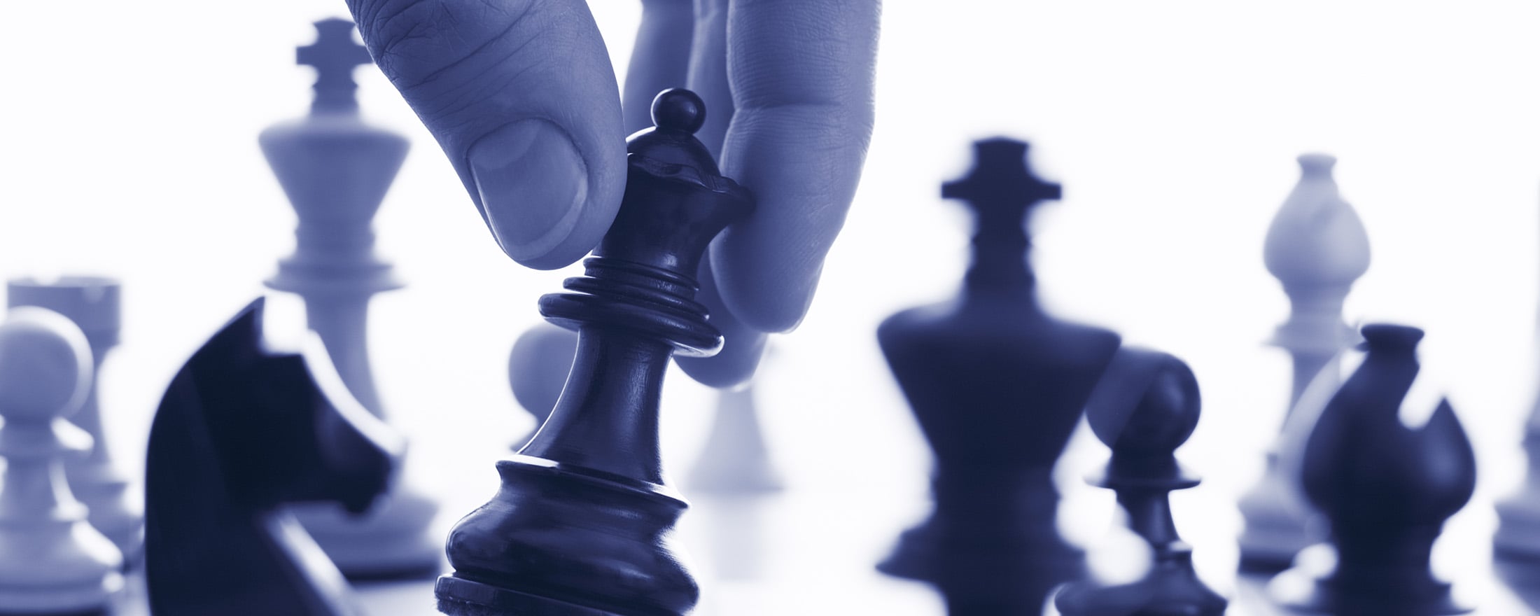 Hand holding chess piece