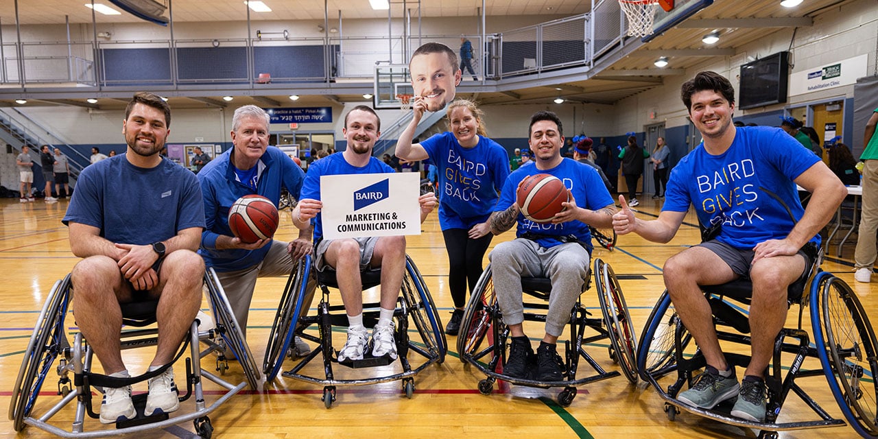 Employees participate in a wheelchair basketball event, promoting inclusion, teamwork, and community impact.