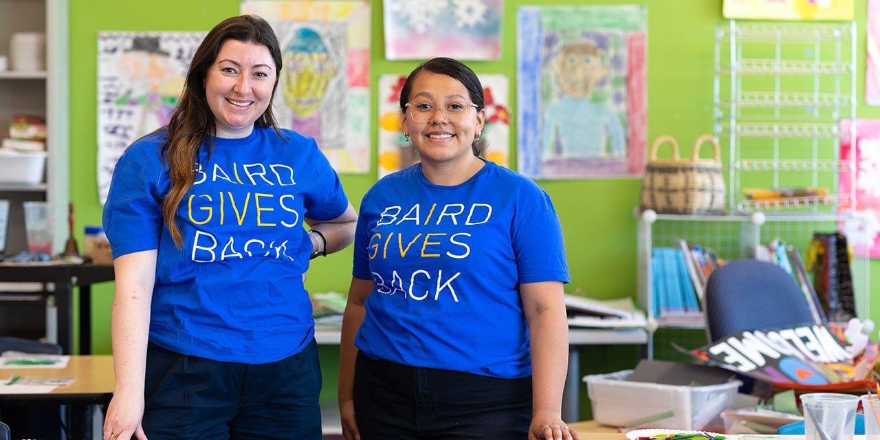 Employees volunteer in a school classroom, supporting youth education and community engagement.