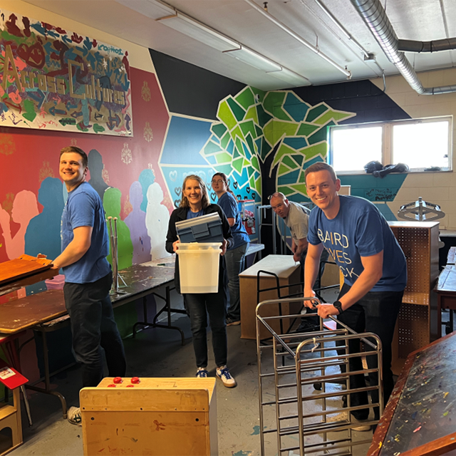 Dynamic indoor volunteer scene with colorful background.