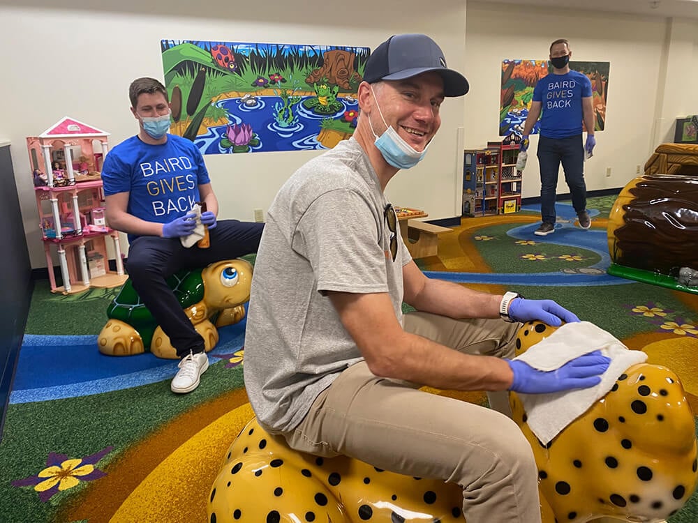 Three Baird associates clean a common area at Ronald McDonald House at Seattle Children's Hospital