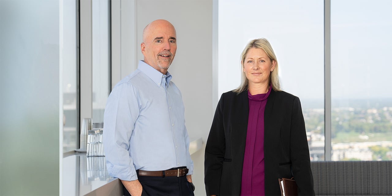 Two members of Baird's Fixed Income Capital Markets Sales and Trading team in an office setting
