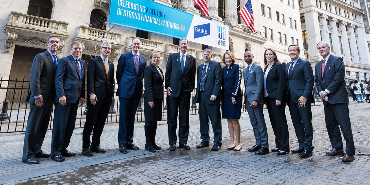 Baird Executive Committee standing in front of the New York Stock Exchange building.