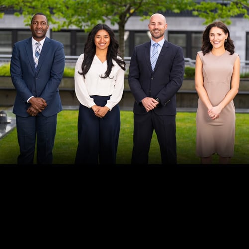 Team photo of the Hamilton Group taken outside their Seattle office building