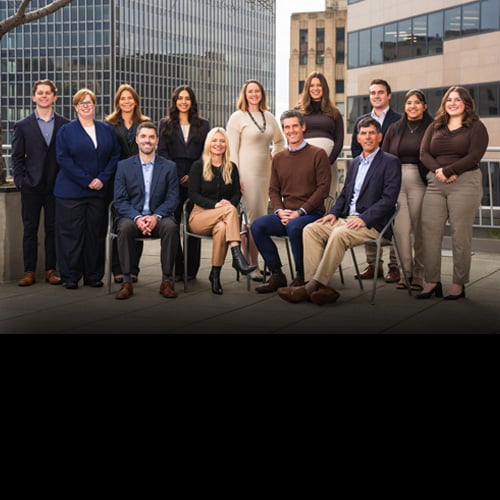 Team photo of the Ragen Group taken outside their Seattle office building