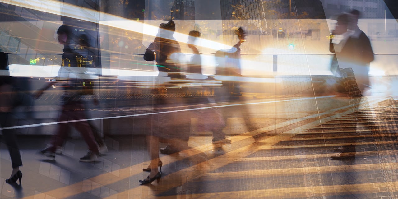 Blurred images of business associates walking through a hallway