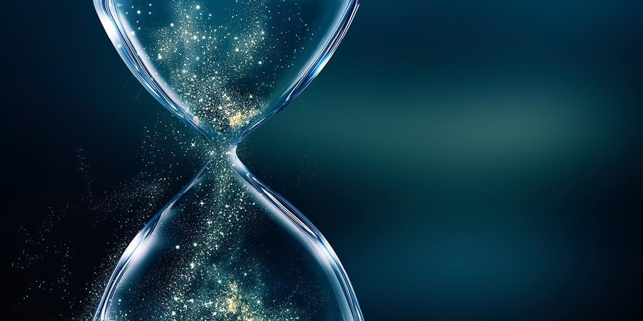 Close-up of an hourglass with shimmering particles emphasizing the passage of time.