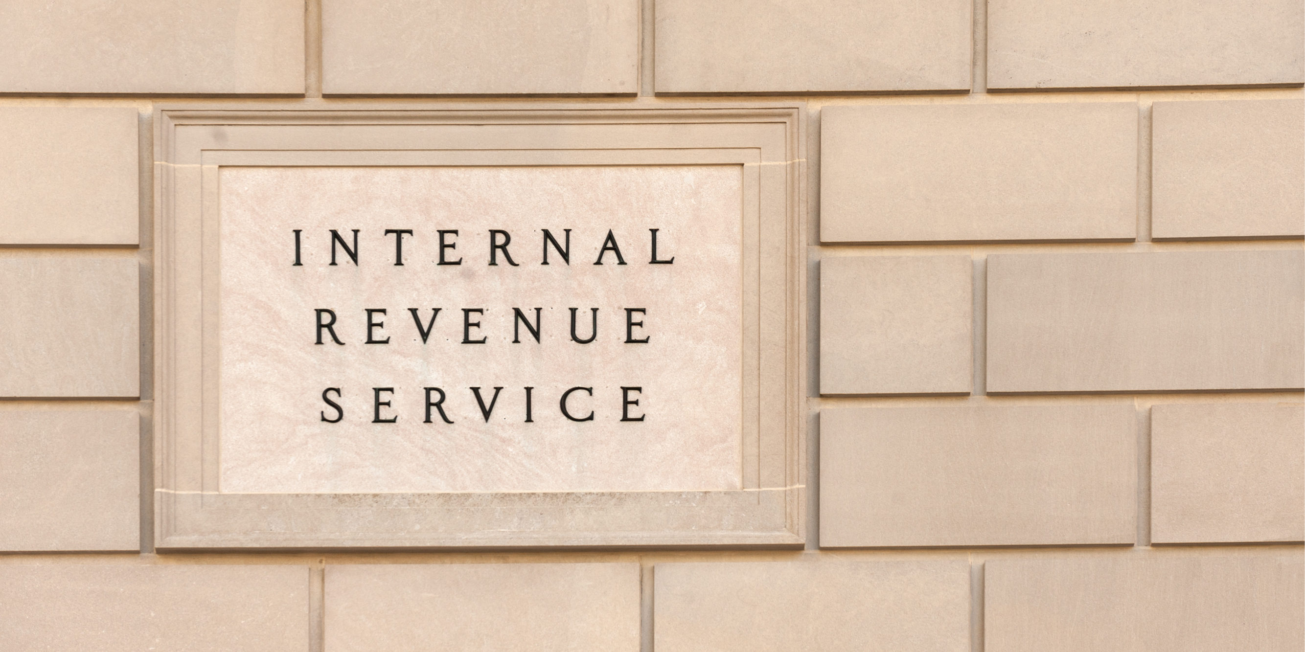 Brick wall with a sign containing the words Internal Revenue Service