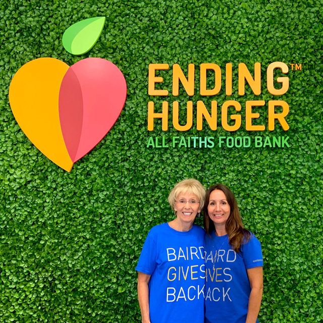 Photograph of two Sarasota associates at All Faiths Food Bank