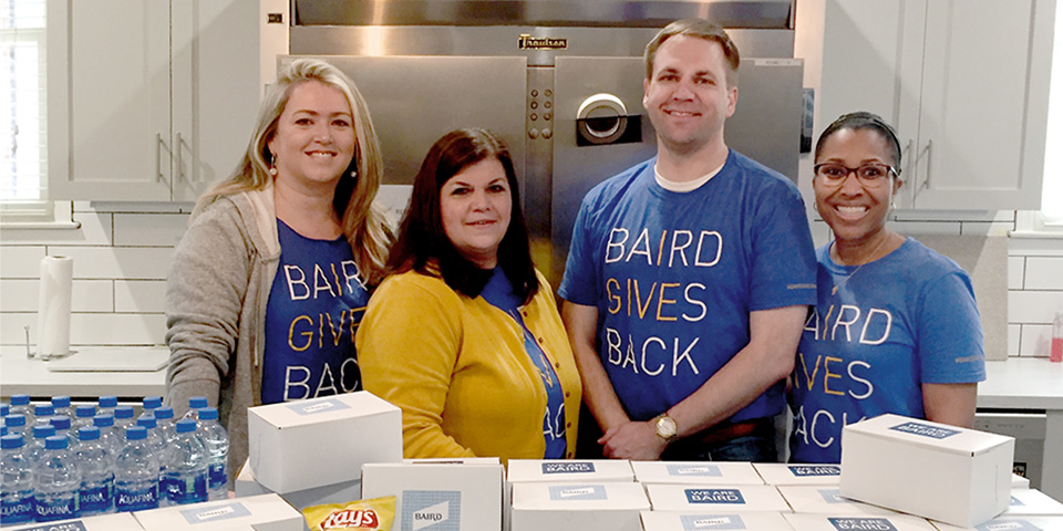 Photograph of Baird Nashville associates putting together box lunches 