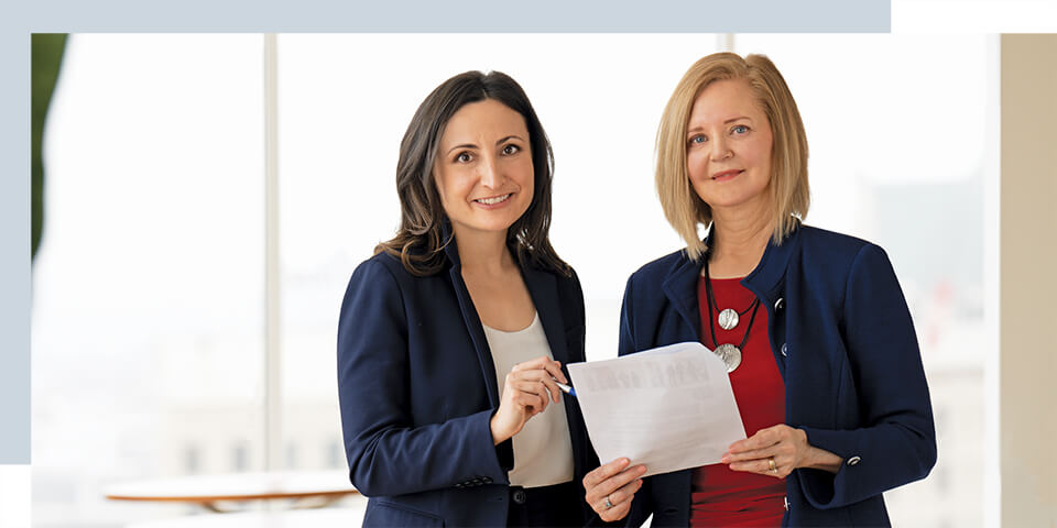 Two associates in Baird's Corporate Resource Groups smile as they review a document