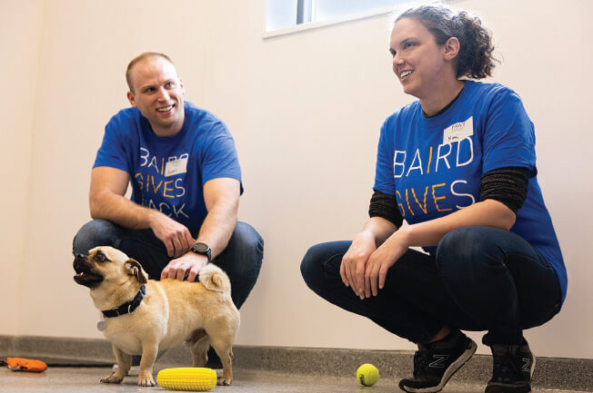 Two Baird associates volunteering at PAWS Chicago