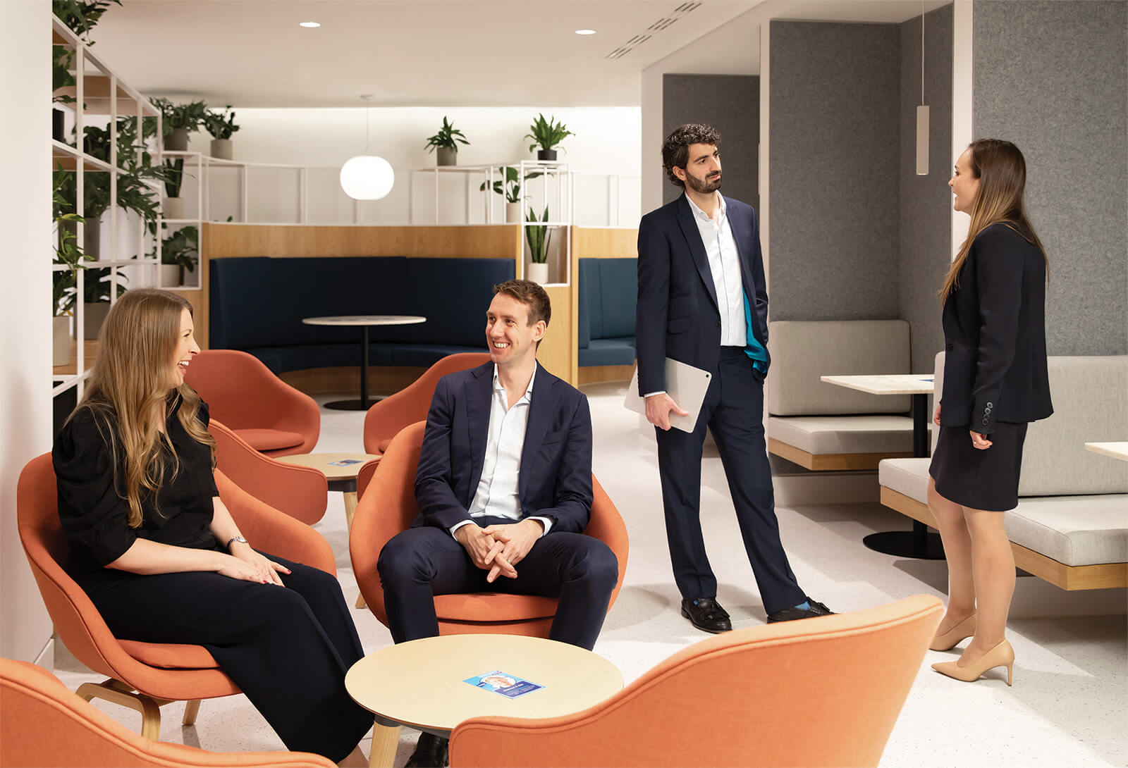 Four associates in the Equities Capital Markets group conversing in an open office setting