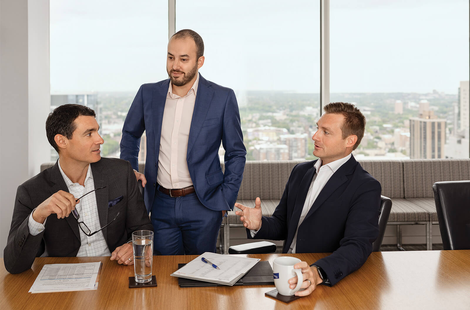 Three associates from the Fixed Income Capital Markets group having a discussion at a conference table