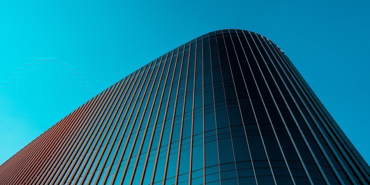 Abstract view of the outside of a building with a bright blue background.