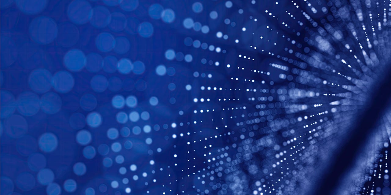 Abstract pattern of white glowing dots spreading outward across a blue background, creating a sense of motion.