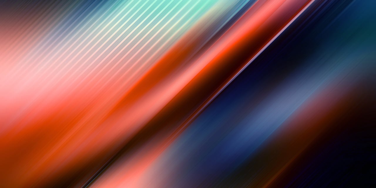 Diagonal streaks of blended red, blue, and teal light creating a smooth, abstract motion effect.